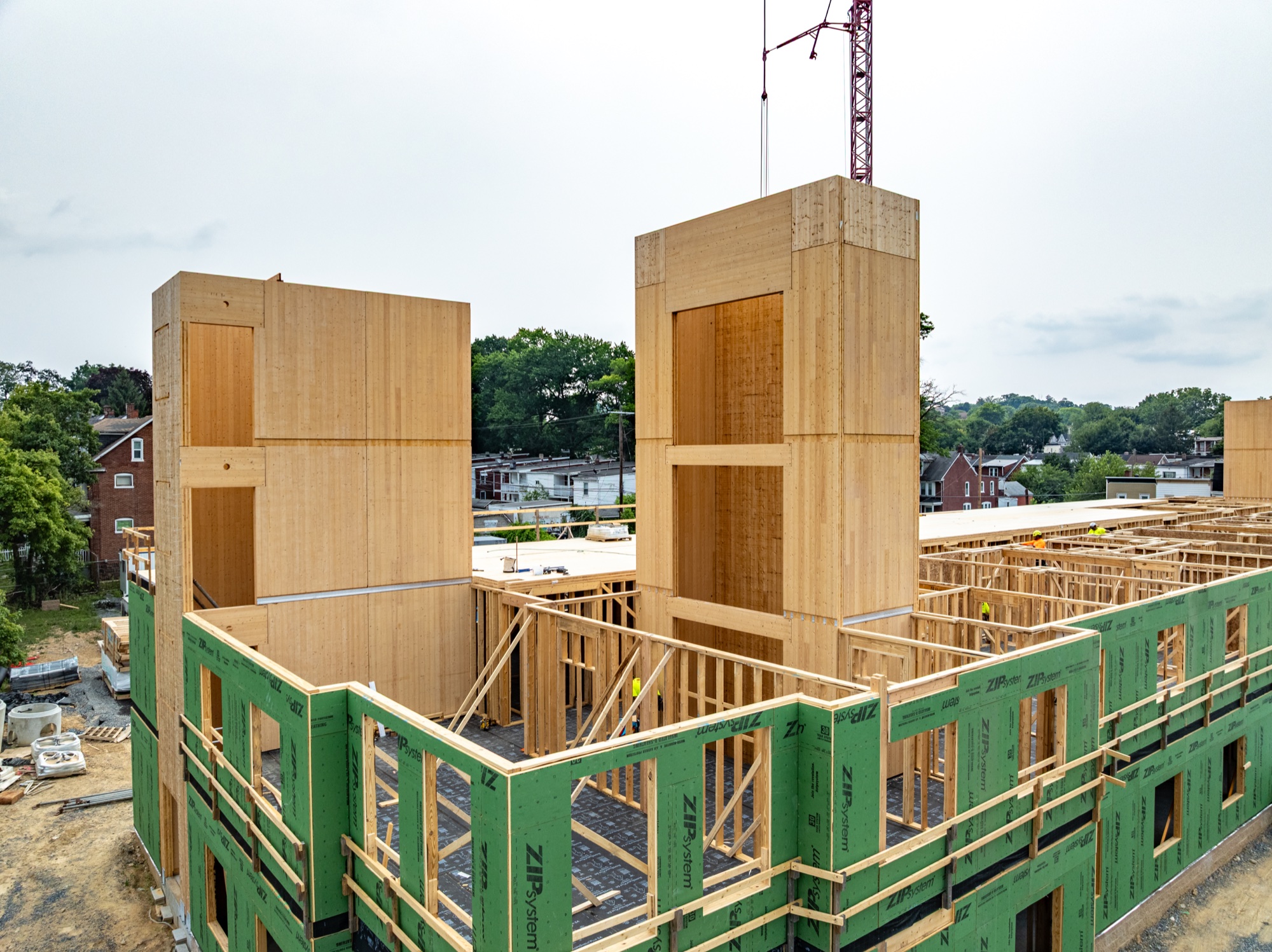 Mass timber stair and elevator towers rising at Woodward Lofts
